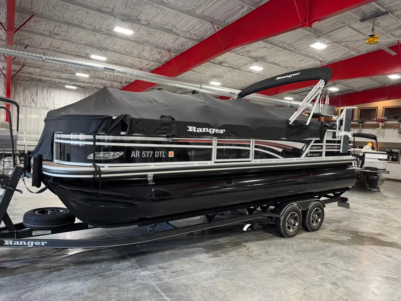 Slide: The Image of 2020 Ranger 223 FC pontoon boat with cover on trailer in indoor storage. - 14