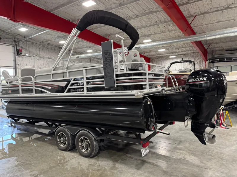 Slide: The Image of 2020 Ranger 223 FC pontoon boat with Mercury outboard motor in a showroom. - 4
