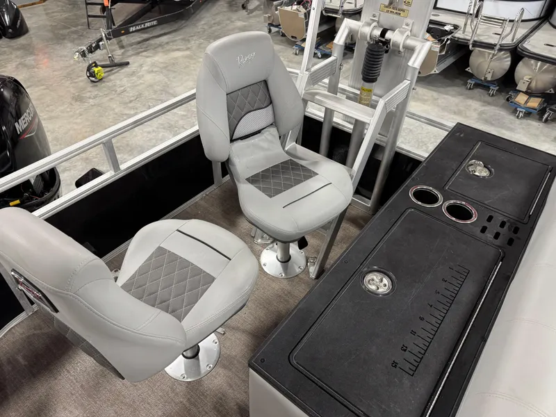 Slide: The Image of 2020 Ranger 223 FC boat interior with two gray seats and a control panel. - 9