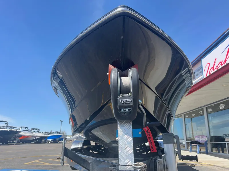 Slide: The Image of 2014 Correct Craft 230 TEAM EDITION boat on trailer, viewed from front, under clear blue sky. - 11