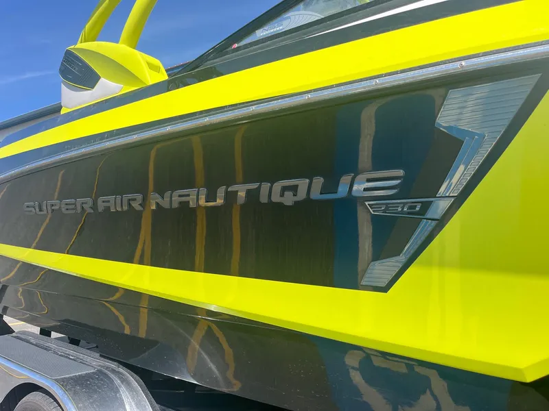 Slide: The Image of 2014 Correct Craft 230 Team Edition boat with vibrant yellow accents. - 14