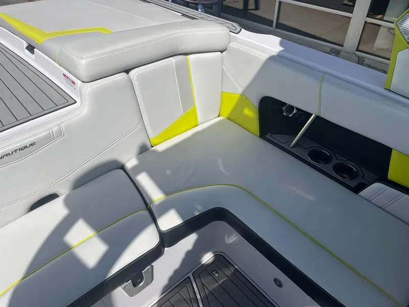 Slide: The Image of Interior seating of 2014 Correct Craft 230 TEAM EDITION boat with gray and yellow accents. - 22