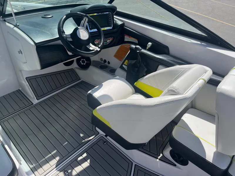 Slide: The Image of 2014 Correct Craft 230 TEAM EDITION boat interior with steering wheel and seating. - 25