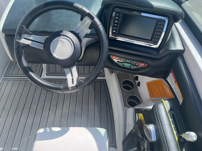 Slide: The Image of Steering wheel and dashboard of 2014 Correct Craft 230 TEAM EDITION boat. - 27