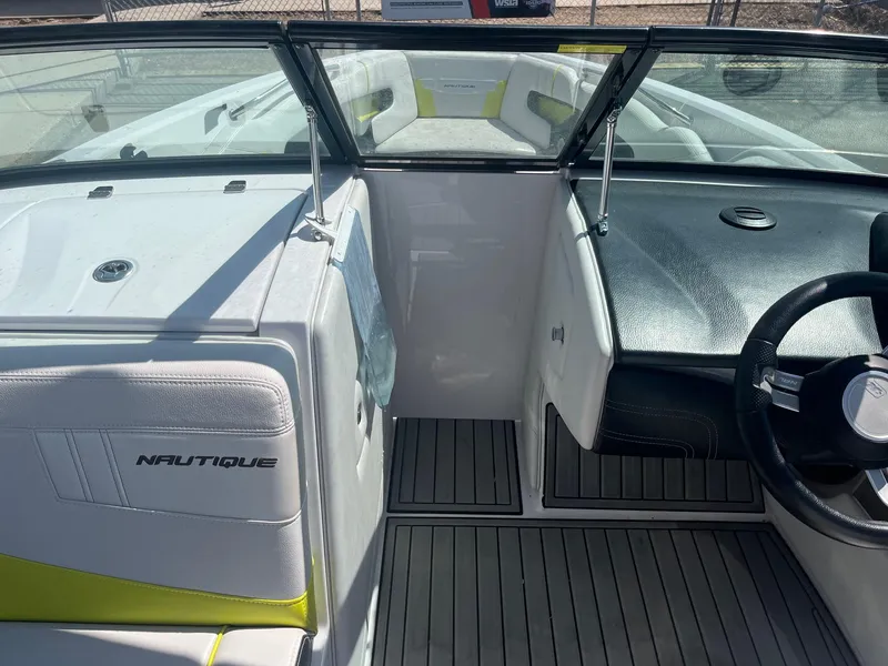 Slide: The Image of 2014 Correct Craft 230 TEAM EDITION boat interior with steering wheel and seating. - 28