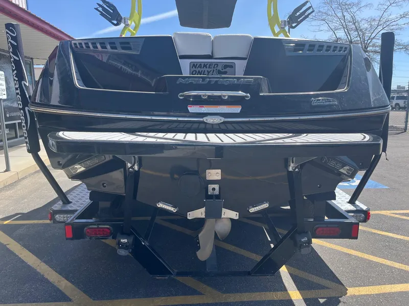 Slide: The Image of 2014 Correct Craft 230 TEAM EDITION boat rear view, parked outdoors. - 4