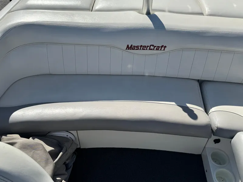 Slide: The Image of 2001 MasterCraft XStar boat interior with white leather seating and logo. - 10