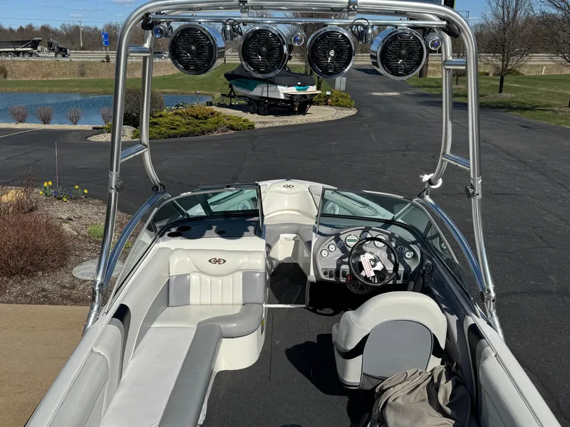 Slide: The Image of 2001 MasterCraft XStar boat with tower speakers, sleek interior, and modern dashboard. - 6