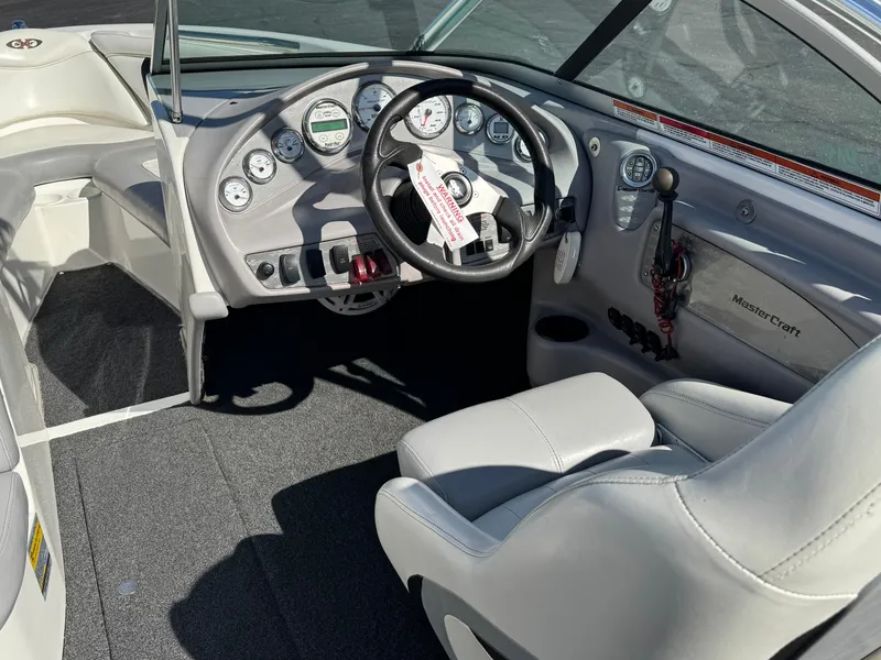 Slide: The Image of 2001 MasterCraft XStar boat interior with steering wheel and dashboard controls. - 7