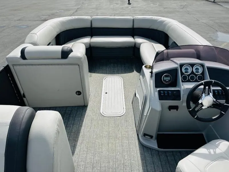 Slide: The Image of 2021 L-Series L5 CLZ boat interior with plush seating and modern dashboard. - 13