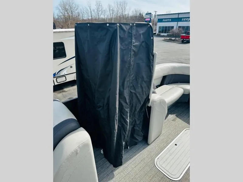 Slide: The Image of 2021 L-Series L5 CLZ boat interior with privacy curtain and seating. - 14