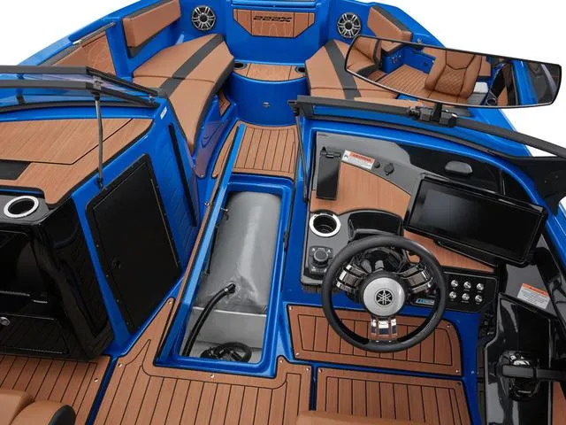 Slide: The Image of 2024 Yamaha Boats 222XD interior with blue accents, modern dashboard, and spacious seating. - 10