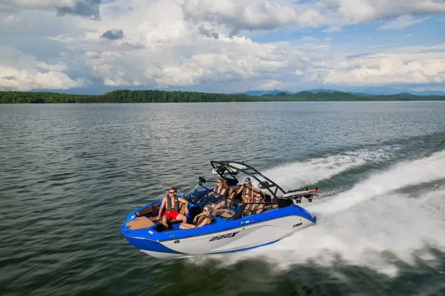 Slide: The Image of 2024 Yamaha Boats 222XD cruising on a lake with passengers enjoying the ride. - 6