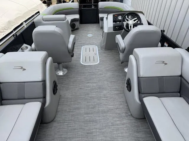 Slide: The Image of 2020 Bennington 22 SSRX boat interior with gray seating and modern dashboard. - 11