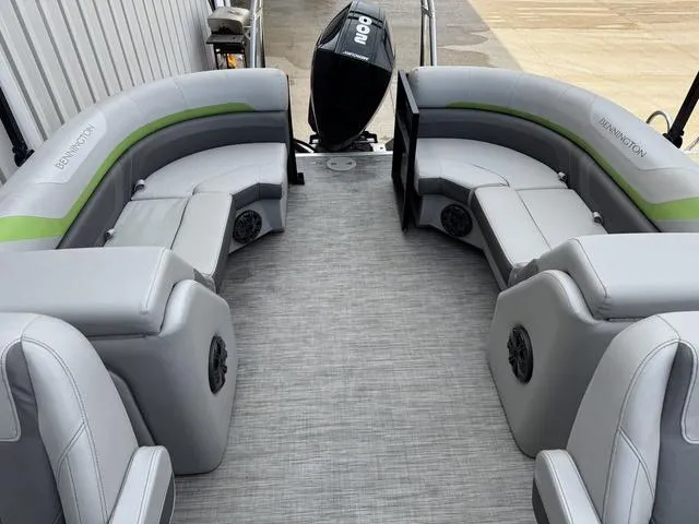 Slide: The Image of 2020 Bennington 22 SSRX pontoon boat with gray seating and green accents. - 8