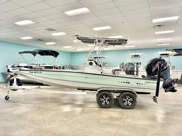 Slide: The Image of 2023 Xpress Boats H22B on trailer in showroom, side view. - 1