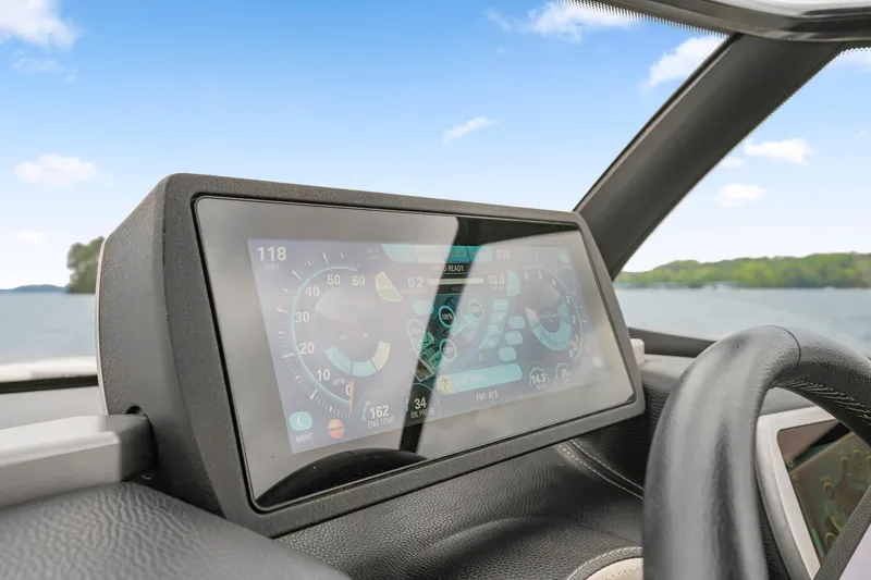 Slide: The Image of Dashboard of 2015 Malibu Wakesetter 24 MXZ boat with digital display on a lake. - 16