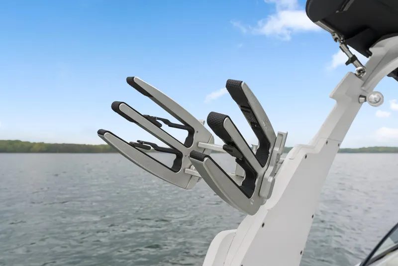 Slide: The Image of Wakeboard rack on 2015 Malibu Wakesetter 24 MXZ against a lake backdrop. - 18