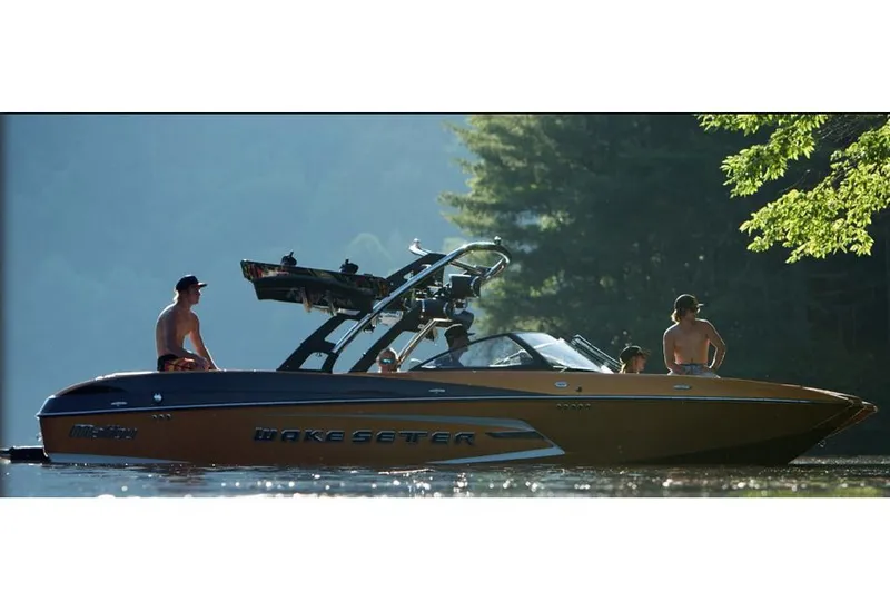 Slide: The Image of 2015 Malibu Wakesetter 24 MXZ boat on a serene lake with people onboard. - 22