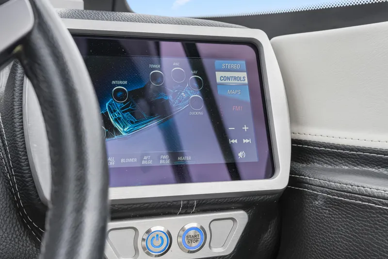 Slide: The Image of 2015 Malibu Wakesetter 24 MXZ dashboard with touchscreen controls and start button. - 3