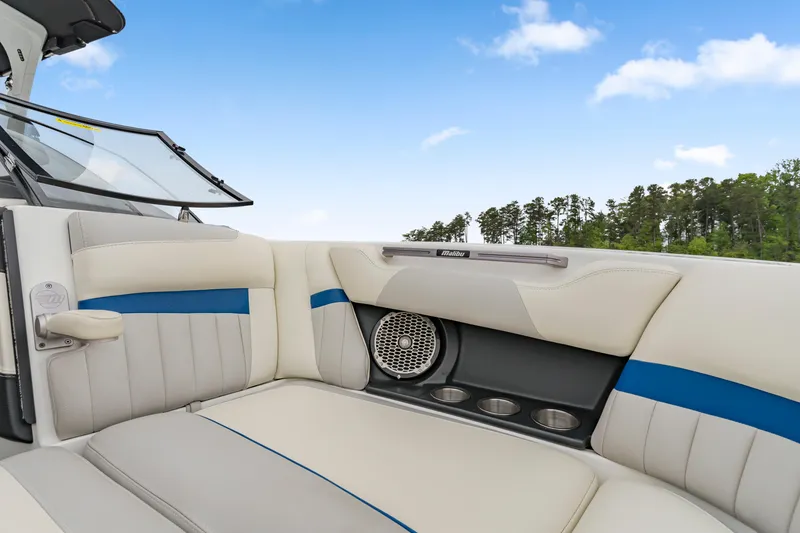 Slide: The Image of 2015 Malibu Wakesetter 24 MXZ interior with white and blue seating, speaker, and cup holders. - 5