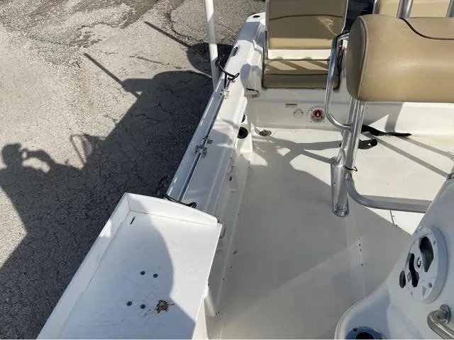Slide: The Image of 2019 NauticStar 215 XTS boat interior with beige seating and white deck. - 10