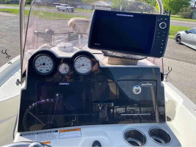 Slide: The Image of 2019 NauticStar 215 XTS boat dashboard with Humminbird and Simrad displays. - 12