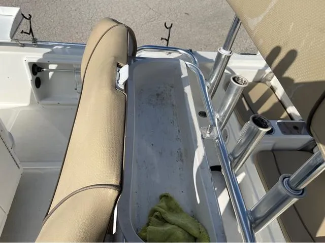 Slide: The Image of 2019 NauticStar 215 XTS boat interior with beige seating and rod holders. - 14