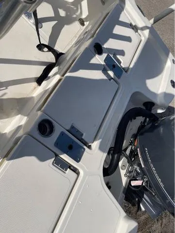 Slide: The Image of 2019 NauticStar 215 XTS boat deck with engine and seating area. - 15