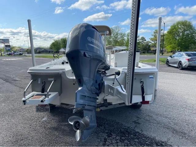 Slide: The Image of 2019 NauticStar 215 XTS boat with Yamaha outboard motor, parked outdoors. - 5