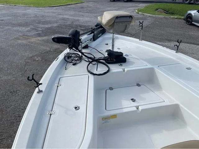 Slide: The Image of 2019 NauticStar 215 XTS boat deck with fishing rod holders and trolling motor. - 7