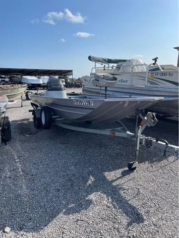 Slide: The Image of 2008 G3 1610 boat on trailer in gravel lot, clear sky background. - 1