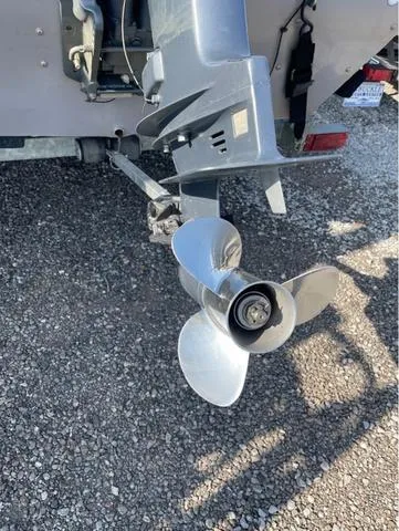 Slide: The Image of Outboard motor propeller on a 2008 G3 1610 boat, parked on gravel. - 6