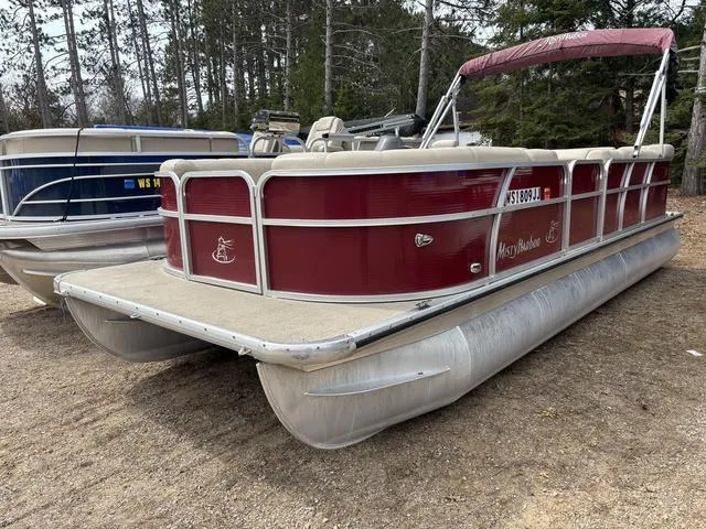 Slide: The Image of 2014 Misty Harbor Boats CR 225 pontoon, red and beige, parked on sandy ground. - 1