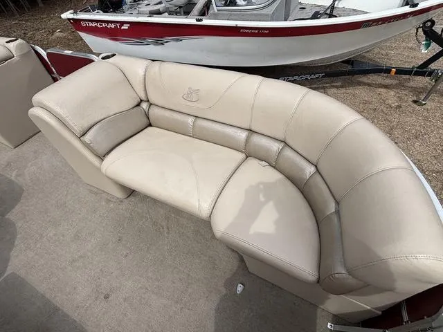Slide: The Image of 2014 Misty Harbor Boats CR 225 beige boat seating with a Starcraft boat in the background. - 10