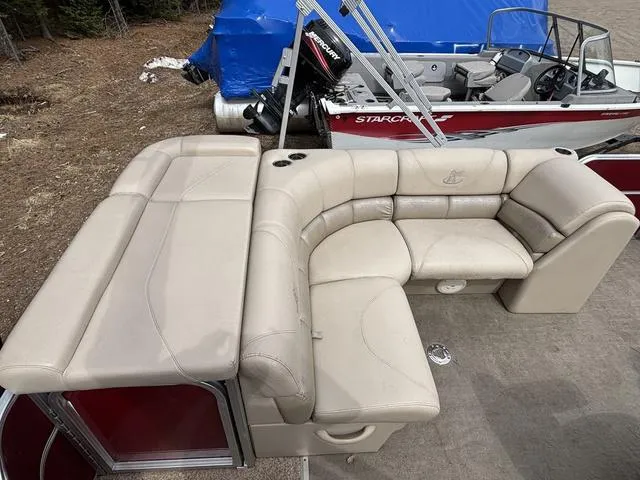 Slide: The Image of 2014 Misty Harbor Boats CR 225 pontoon with beige seating and cup holders. - 12