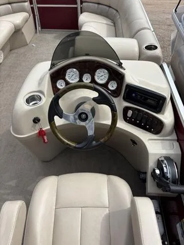 Slide: The Image of 2014 Misty Harbor Boats CR 225 dashboard with steering wheel and control panel. - 14