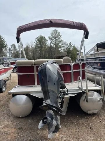 Slide: The Image of 2014 Misty Harbor Boats CR 225 pontoon with outboard motor, parked on gravel. - 5