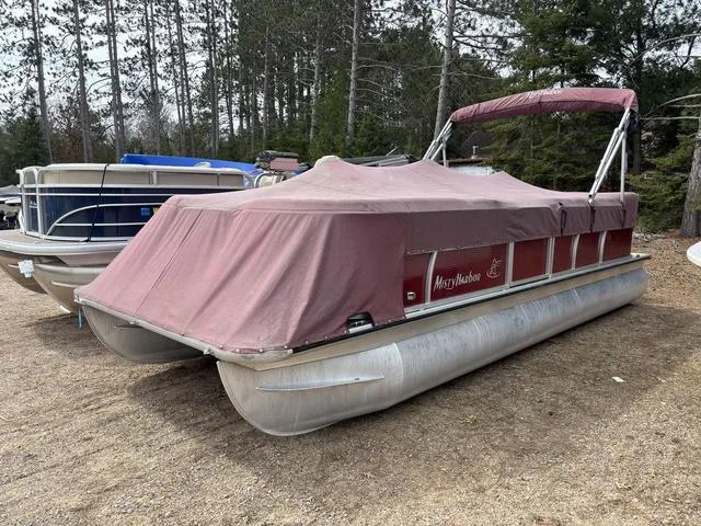 Slide: The Image of 2014 Misty Harbor Boats CR 225 pontoon with cover, parked on gravel, surrounded by trees. - 7