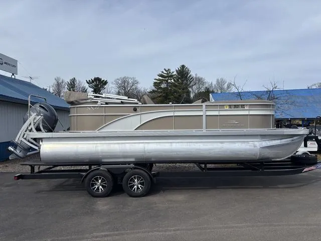 Slide: The Image of 2020 Bennington 22 SSX pontoon boat on trailer, parked outdoors. - 1