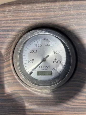 Slide: The Image of Tachometer of 2020 Bennington 22 SSX showing RPM on wood-textured dashboard. - 13