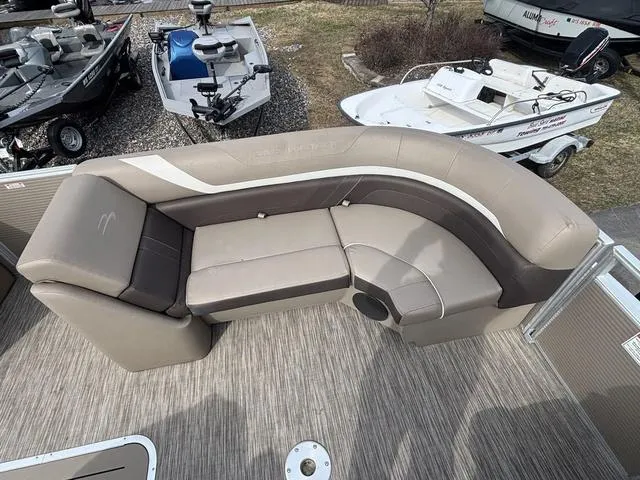 Slide: The Image of 2020 Bennington 22 SSX pontoon boat with beige and brown seating on deck. - 9
