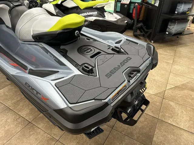 Slide: The Image of 2025 Sea-Doo Waverunner RXT-X, sleek design, displayed indoors on tiled floor. - 14