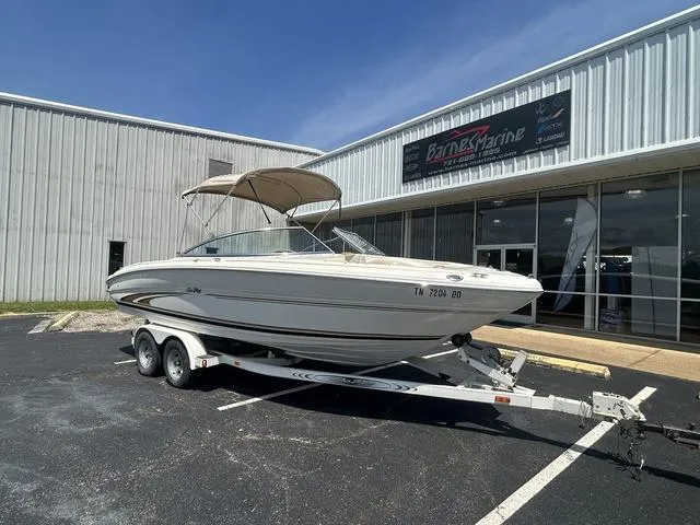 Slide: The Image of 2000 Sea Ray 210 Signature boat on trailer outside Barnes Marine dealership. - 1