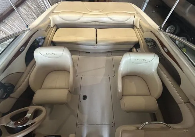 Slide: The Image of Interior of a 2000 Sea Ray 210 Signature boat with beige seating and steering wheel. - 3