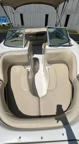 Slide: The Image of 2000 Sea Ray 210 Signature boat with beige seating and open windshield. - 4