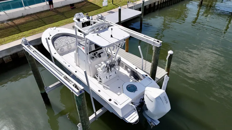 Slide: The Image of 2022 Xplor x24 Andros Mercury 300 boat with tower, docked on a lift. - 1