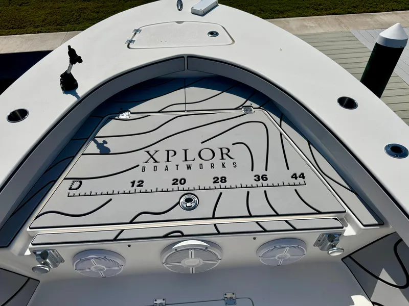 Slide: The Image of 2022 Xplor x24 Andros Mercury boat deck with Xplor Boatworks branding and measurement markings. - 15