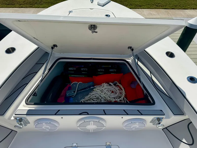 Slide: The Image of Open storage compartment on 2022 Xplor x24 Andros Mercury boat, showing ropes and equipment. - 16