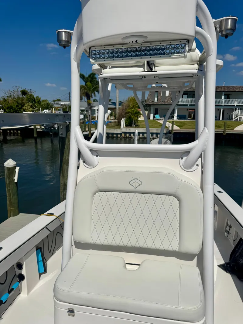 Slide: The Image of 2022 Xplor x24 Andros Mercury 300 boat with tower, docked by waterfront homes. - 19